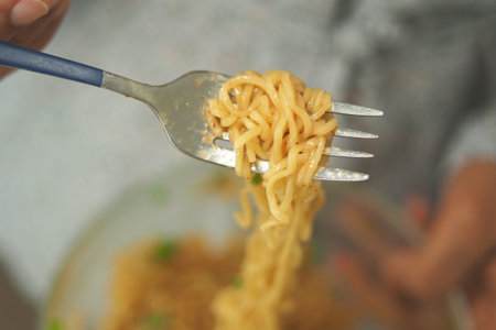 Delicious noodles served on a fork during a meal