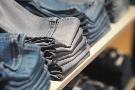 Jeans neatly stacked in a clothing store display