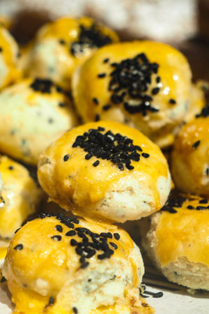 Savory cheese-filled pastries with black sesame seedsの写真素材