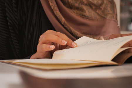 Reading a book while wearing a scarf indoors