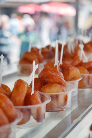 Delicious turkish donut displayed in a bustling marketの写真素材