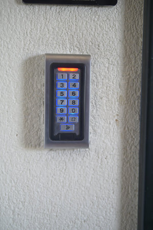 Keypad entry device mounted on a wall for secure access