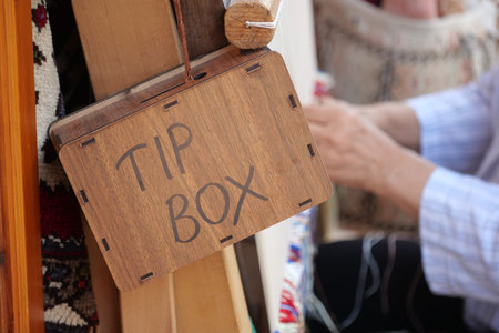 Craftsperson prepares handmade items at busy market