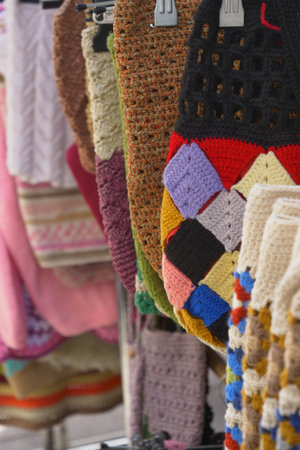 Colorful handwoven textiles displayed at a local marketの写真素材