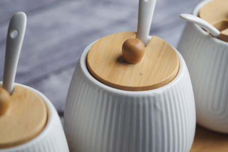 Elegant white ceramic containers with bamboo lids displayed