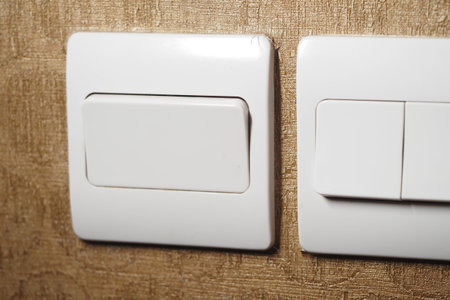 Light switches on textured wall in indoor setting