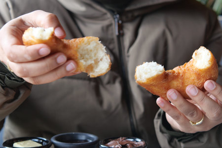 Delicious person enjoying freshly baked bread in hands