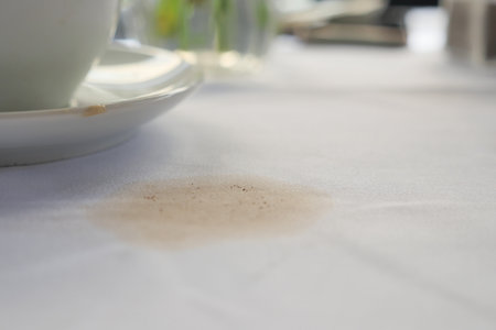 Coffee stain on white tablecloth in outdoor cafeの写真素材