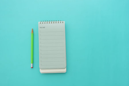 Green pencil and checklist on a blue background