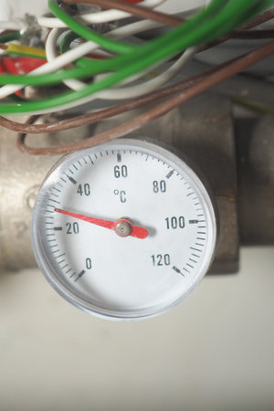 Temperature gauge indicating heat levels on a pipe