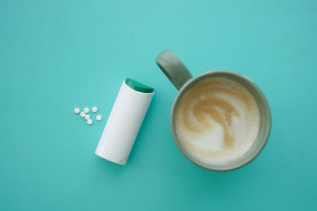 Artificial sweeteners and a cup of coffee on color background ,の写真素材