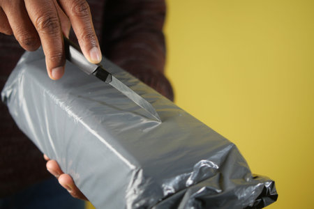 Unwrapping a package gently in bright light