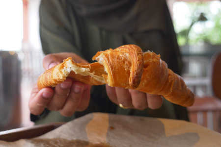 Freshly baked croissant displayed in a cozy cafe