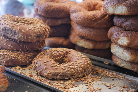 Freshly baked bagels with seeds on a display table