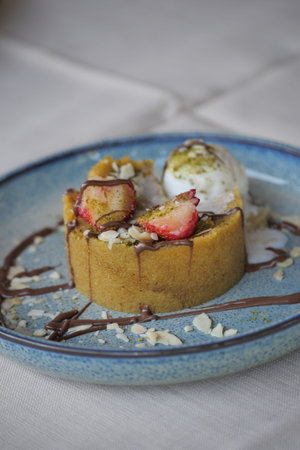 Delicious dessert topped with fruits and ice cream at cafe
