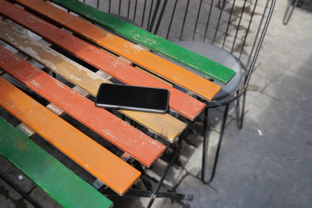 Brightly colored table with a smartphone resting on it, lost smart phoneの写真素材
