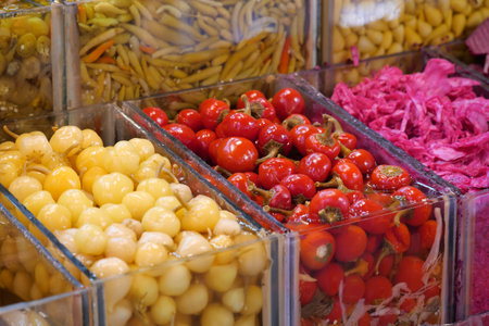 Colorful selection of preserved vegetables at a marketの写真素材