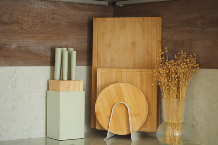 Bamboo cutting boards and vase on kitchen counter