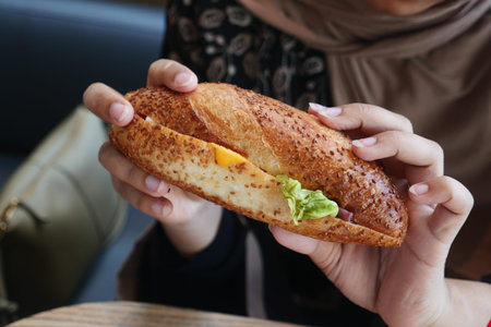 Delicious sandwich held by a person in casual setting