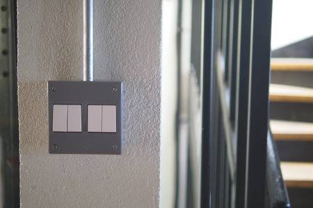 Light switch by staircase in modern building