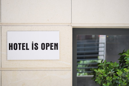 Hotel welcomes guests with open sign announcementの写真素材