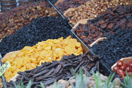 Colorful assortment of dried fruits at a market stall