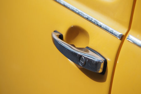 Vintage car door handle in bright yellow colorの写真素材