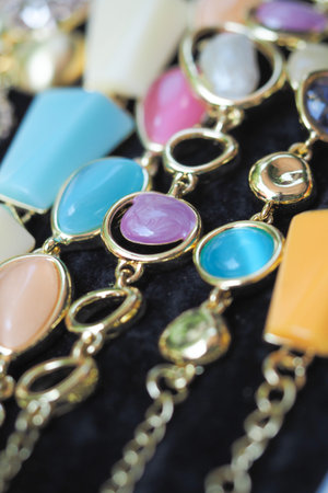 Colorful gemstones arranged on black fabric for display
