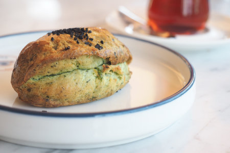 Freshly baked herb scone with tea at a cozy cafe
