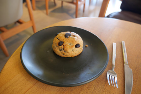 Freshly baked cookie on a wooden table in a cafeの写真素材