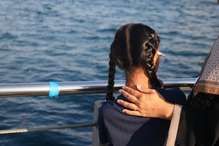 Child enjoying time by the water with a close companion