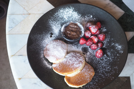 Fresh pancakes with strawberries and chocolate spreadの写真素材
