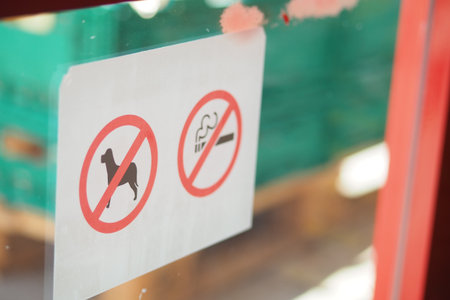 No dogs or smoking signs on storefront window in daytimeの写真素材