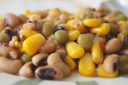 Colorful dish of beans and corn served on a plateの写真素材