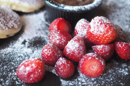 Fresh strawberries dusted with powdered sugar and dessertの写真素材