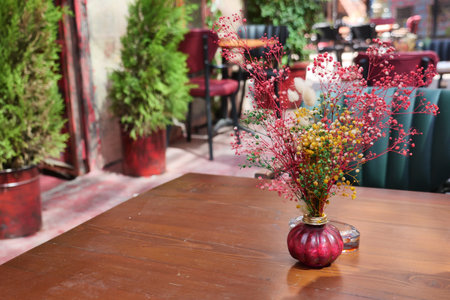 Elegant centerpiece with dried flowers in a cozy settingの写真素材