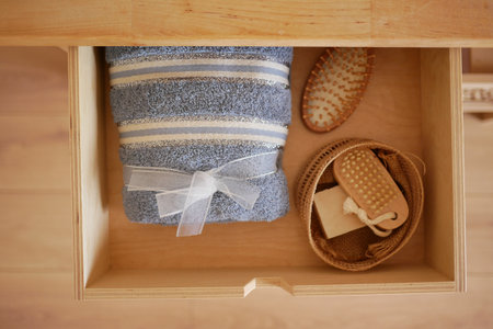 Neatly arranged bathroom essentials in a wooden drawerの写真素材