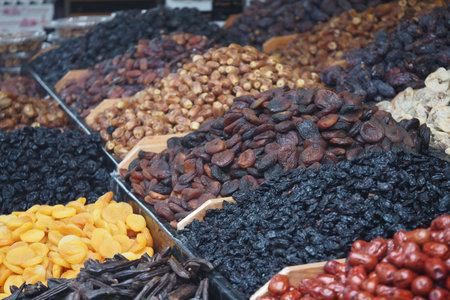 Colorful display of dried fruits in local marketの写真素材