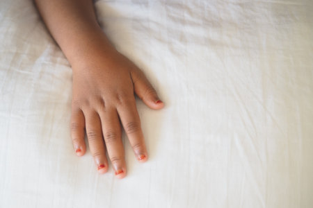 Child Hand resting on a soft white surfaceの写真素材