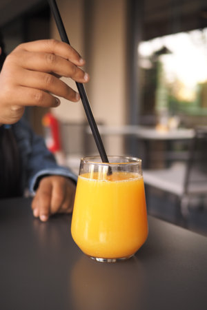 Refreshing orange drink enjoyed in a modern cafeの写真素材