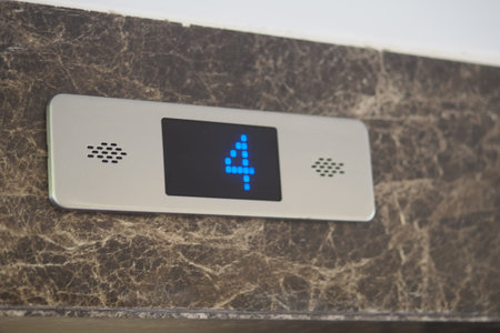 Electronic display shows fourth floor in modern elevator