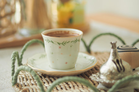 Turkish Coffee served in a decorative cup with saucer on a tableの写真素材