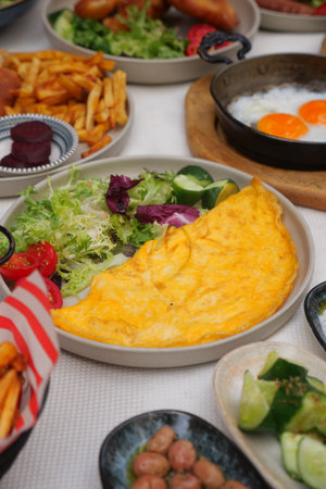 Delicious breakfast spread featuring omelette and sidesの写真素材