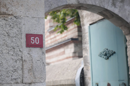 Historic entrance of building number 50 in old cityの写真素材