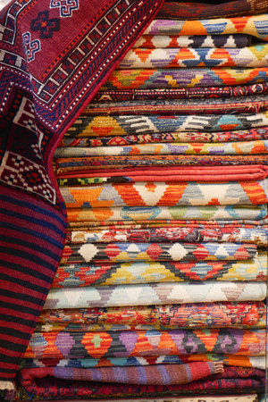 Colorful woven textiles displayed in a market setting