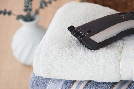 Grooming tools on neatly stacked towels in a cozy settingの写真素材