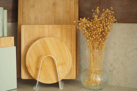 Natural kitchen decor with wooden cutting boards and flowersの写真素材