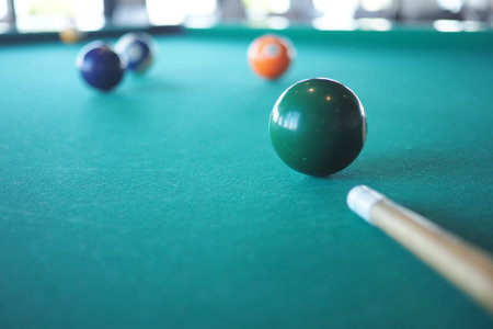 Colorful billiard balls on a green felt table