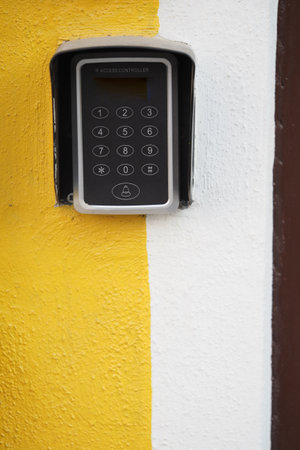 Keypad entry system mounted on a colorful wallの写真素材