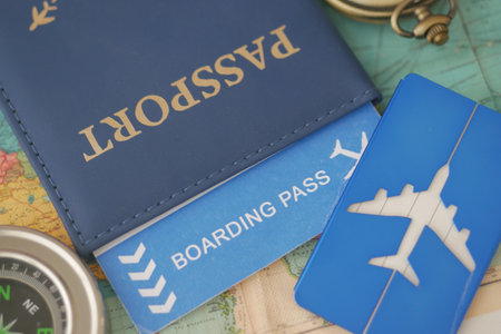 Preparing for travel with passport and boarding pass on mapの写真素材